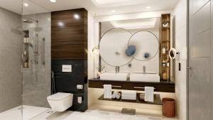 ein Badezimmer mit 2 Waschbecken und einem Spiegel in der Unterkunft Conrad Bahrain Financial Harbour in Manama