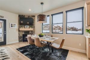 a dining room with a table and chairs and windows at Helling Circle Secret 102 condo in Heber City