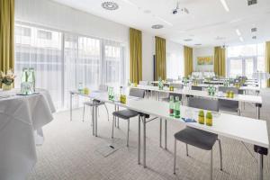 a room with tables and chairs with soda bottles on them at Best Western Hotel Tulln in Tulln