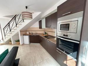 a kitchen with stainless steel appliances and a staircase at Villa Buenavistas in Adeje