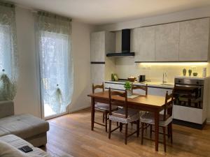 a kitchen and dining room with a table and chairs at APPARTAMENTO ZANARDI 27 in Bologna