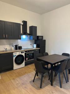 a kitchen with a table with chairs and a microwave at Convenient & Central Apartment in Dublin