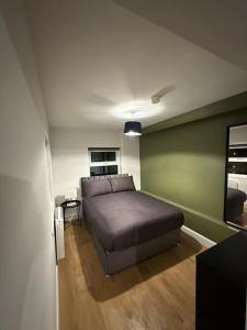 a bedroom with a bed and a table in it at Convenient & Central Apartment in Dublin