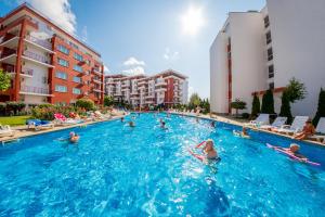 a group of people swimming in a swimming pool at Panorama Fort Beach in Sveti Vlas