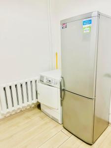 a refrigerator and a dishwasher in a room at Ezero apartamentai in Šiauliai