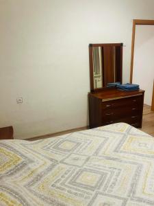 Un dormitorio con una cama, una cómoda y un espejo. en Ezero apartamentai, en Šiauliai 12 fotos más
