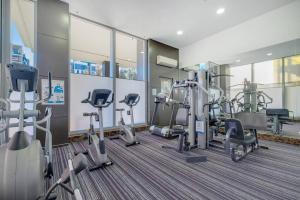 a gym with treadmills and cardio equipment in a building at Lovely home with pool in Zetland in Sydney