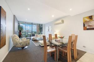 a dining room with a table and chairs at Lovely home with pool in Zetland in Sydney