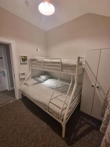 a bedroom with two bunk beds in a room at The Monkey Puzzle in Bunclody