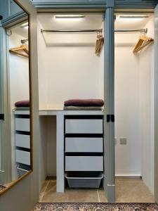 a walk in closet with a vanity and mirror at Enchanting 1 Bedroom Home with Kitchen in Saffron Walden