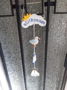a seagull ornament hanging from a glass window at Haus Gori in Haffkrug