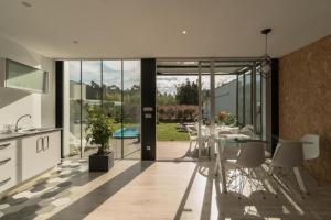 a kitchen and dining room with a glass table at Casa Calima in Esteiro