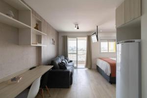 a living room with a couch and a bed at Skyline Studio - GRU 1503 in Guarulhos +67 photos
