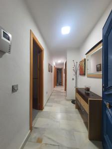 a hallway with a door and a tile floor at MALDONADO LUJO SUPERIOr CENTRO MALAGA in Málaga