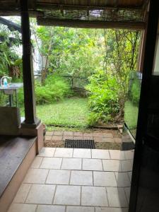 an open door to a patio with a view of a garden at Highbury Colombo in Colombo