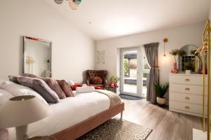 ein Schlafzimmer mit einem großen Bett und einem Spiegel in der Unterkunft Paisley Cottage in Sandwich