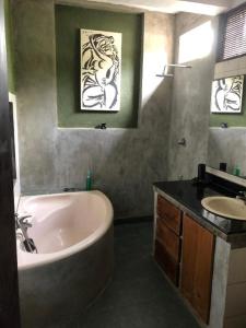 a bathroom with a bath tub and a sink at Highbury Colombo in Colombo
