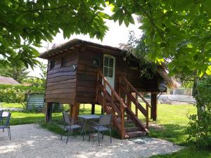 a tree house with a table and chairs at La paillote idyllique in Faverolles-sur-Cher