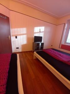 1 dormitorio con 1 cama y TV en Paulibude en Hamburgo