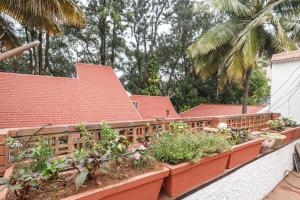 a garden on the side of a house at Woodstone Manor by JadeCaps Penthouse Indiranagar in Bangalore