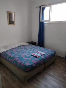 a bedroom with a bed in a room with a window at Studio centre ville Agadir in Agadir