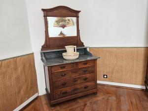 a wooden dresser with a mirror on top of it at Château de Chazelpaud in Saint-Bard