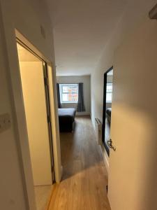 a hallway with a door and a couch in a room at Central & Spacious Centre Apt in Dublin