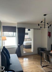 a living room with a bed and a table and chairs at Central & Spacious Centre Apt in Dublin