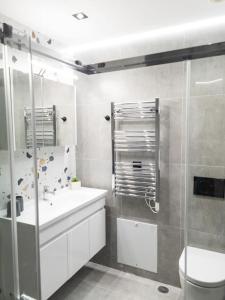 a bathroom with a toilet and a sink and a shower at Camellia Suite - 5 min drive to Piraeus Port in Piraeus