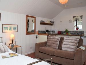 a living room with a couch and a kitchen at 1 bed property in Crackington Haven 36500 in Egloskerry