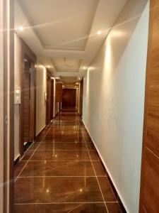 a hallway of a building with a tile floor at Hotel Red Blue,Ahmedabad in Naroda