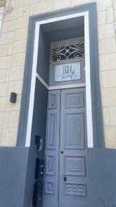 a door to a building with a sign above it at Sliema Distant Seaview Penthouse in Sliema
