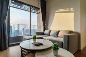 salon z kanapą i stołem oraz dużym oknem w obiekcie Luxury 2 Bedrooms Condo Checkin 24h Infinity Pool 360 w mieście Bangkok