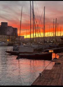 a group of boats docked at a marina at sunset at Partenope 10 in Naples