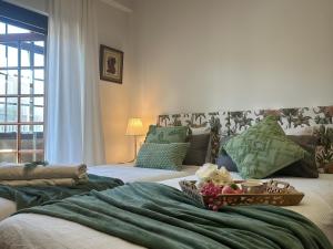 a room with a bed with a bowl of flowers on it at Maison Terrasse Doña Irma in Cambados