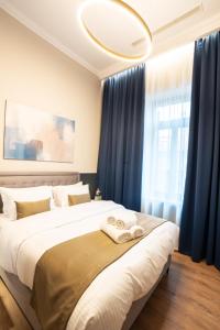 a bedroom with two beds with blue curtains at Oikia Classic House in Kavala