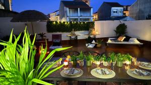 a table with plates of food and plants on a patio at Maison Terrasse Doña Irma in Cambados