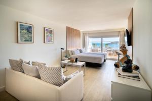 a hotel room with a bed and a living room at INNSiDE by Meliá Wave Calviá in Magaluf
