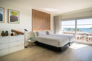 a bedroom with a bed and a view of the ocean at INNSiDE by Meliá Wave Calviá in Magaluf