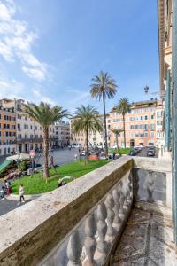 - un balcon offrant une vue sur une ville bordée de palmiers dans l'établissement Residenza Pierret, à Rome