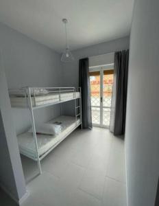 a room with two bunk beds and a window at Les Amis appartamento anzio in Anzio
