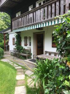 a house with a porch with a bench and a table at Ferien Haus am Feldgarten mit 160 qm für 2 bis 9 Personen in Raubling +33 photos