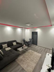 a living room with a couch and a table at Familien Apartment in Niederaigen