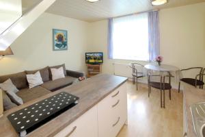 a living room with a couch and a table at Haus Waterkant in Breege