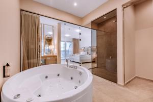 a large bathroom with a tub and a shower at Vila Bisera in Ohrid