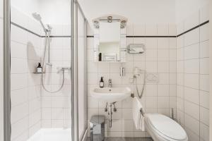 a bathroom with a shower and a sink and a toilet at Serviced-Appartements-Josefstadt in Vienna