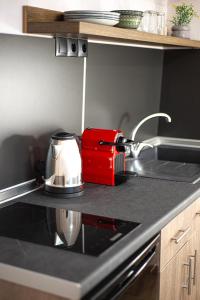 a red toaster sitting on a counter in a kitchen at Zante Art de l'eau in Zakynthos Town