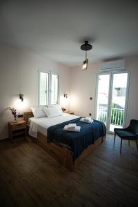 a bedroom with a large bed and a large window at Zante Art de l'eau in Zakynthos