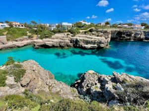a view of a body of water with rocks at La Vall - Apartamento en planta baja con piscina in Cala en Blanes