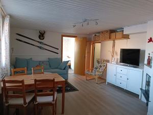 a living room with a table and a blue couch at Large apartment with sauna in central Mora in Mora